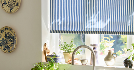 roller blind in a kitchen with a cat in front of it